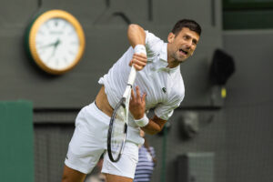 Novak Djokovic serves at Wimbledon 2023